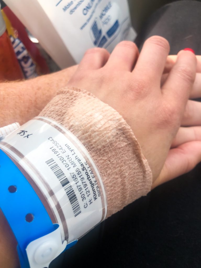 Sarah and Troy Klongerbo holding hands after their miscarriage
