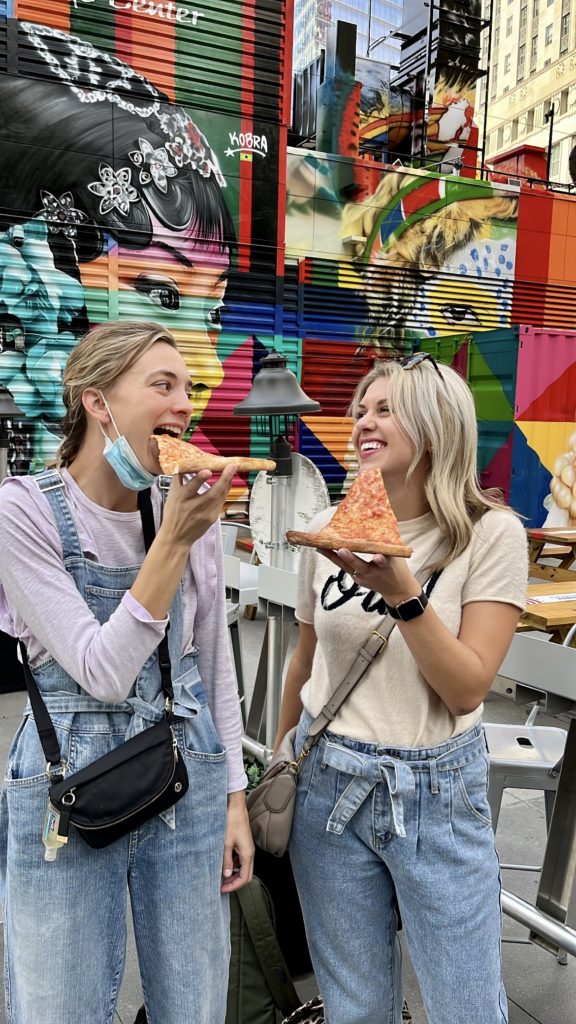 Sarah Klongerbo and her friend enjoying pizza in NYC