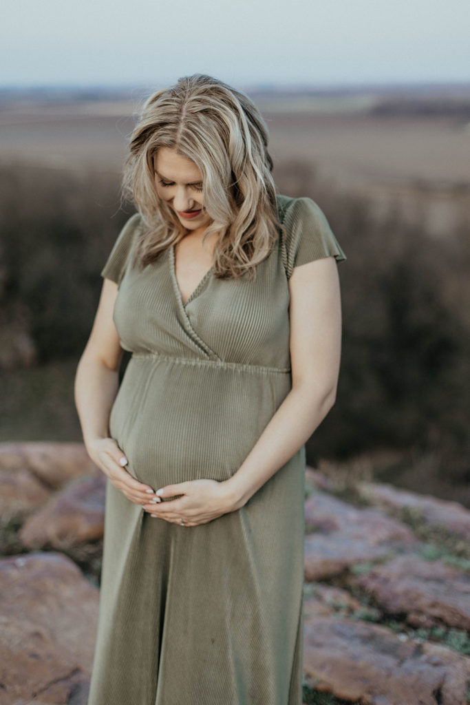 Sarah Klongerbo, looking down in wonder at her child while pregnant