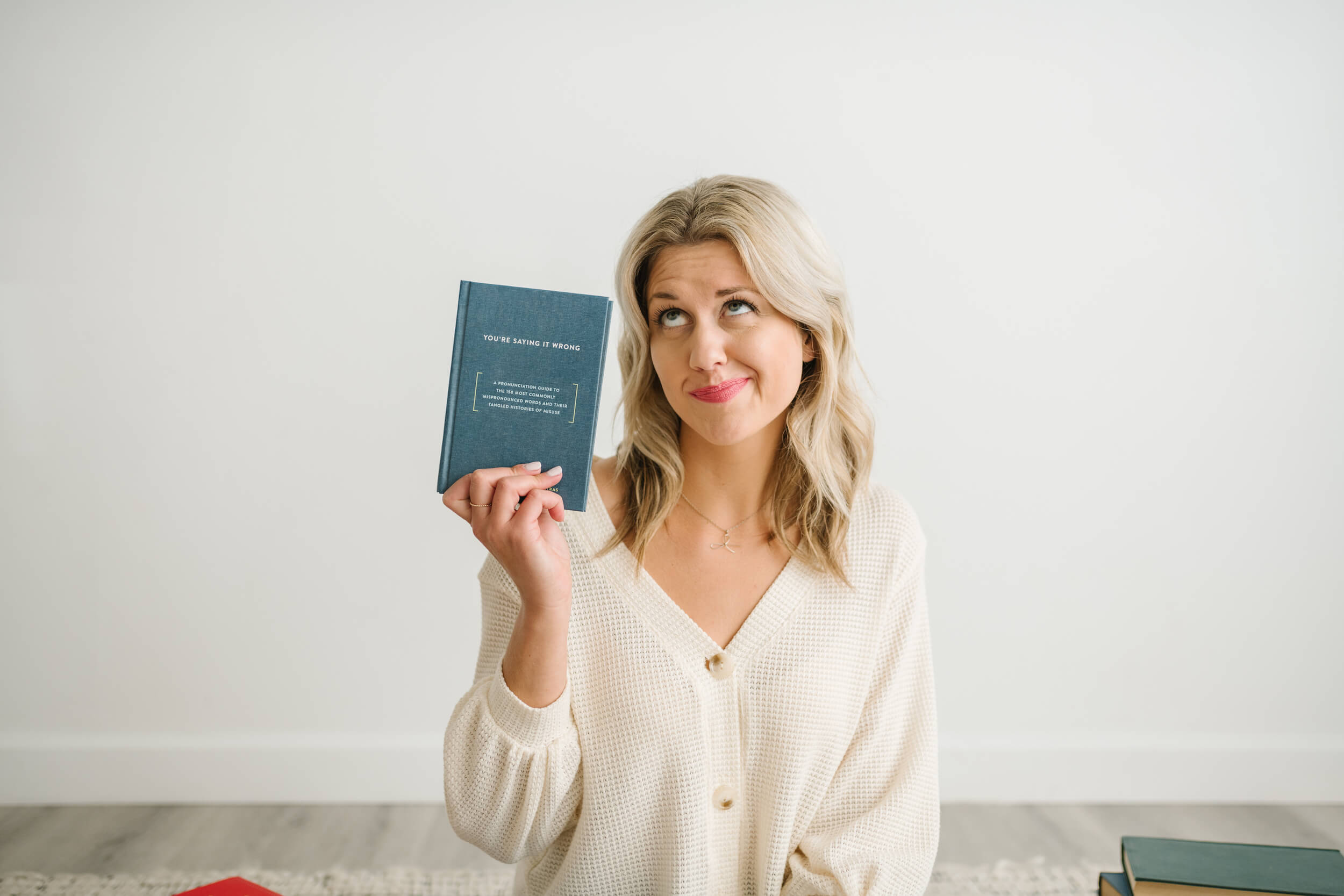 Sarah Klongerbo holding a book about editing tips for marketers